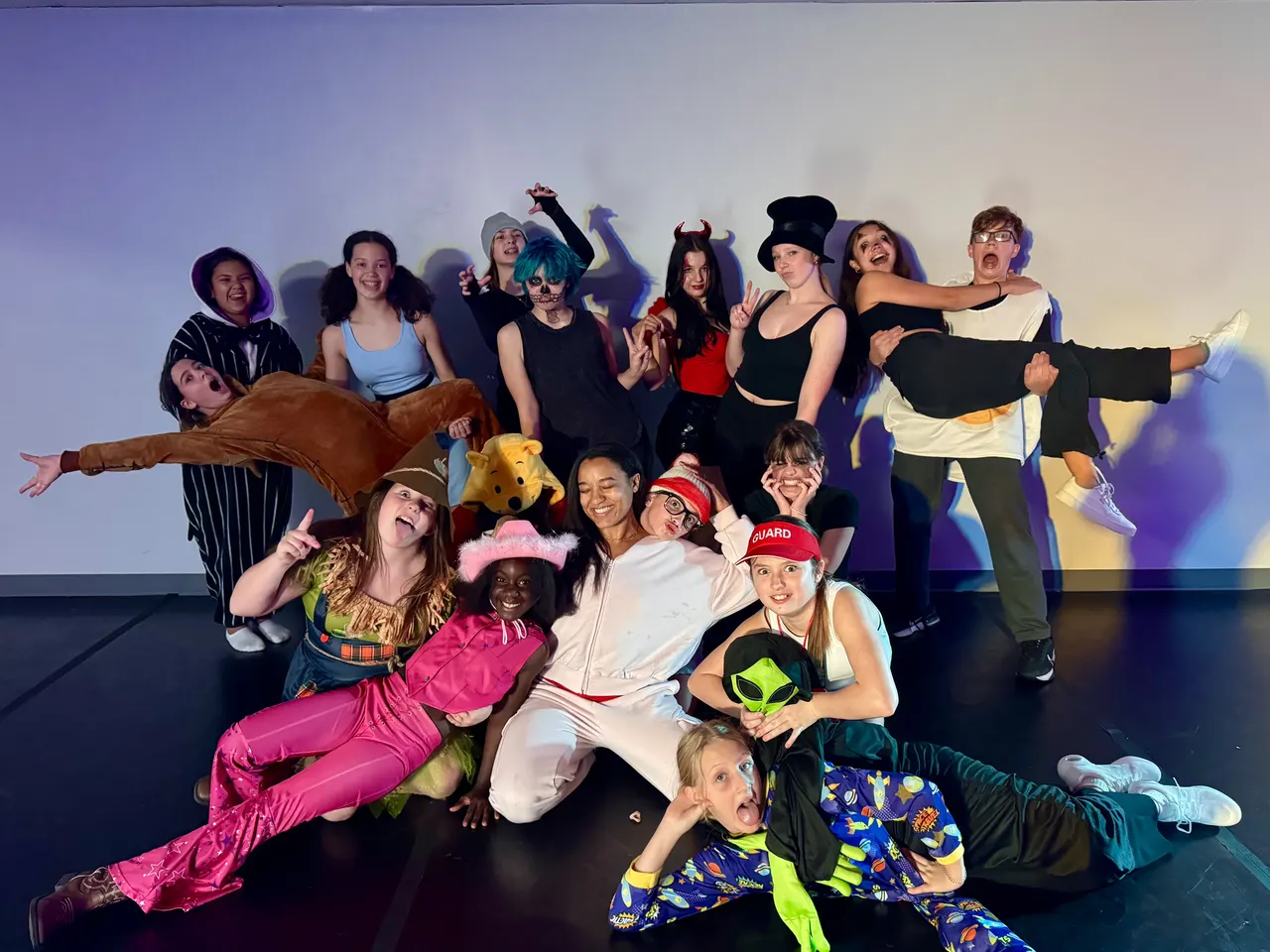 A cast in colourful costumes