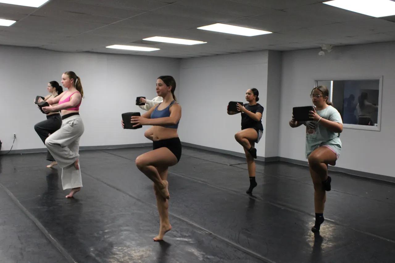 Dancers balancing in class